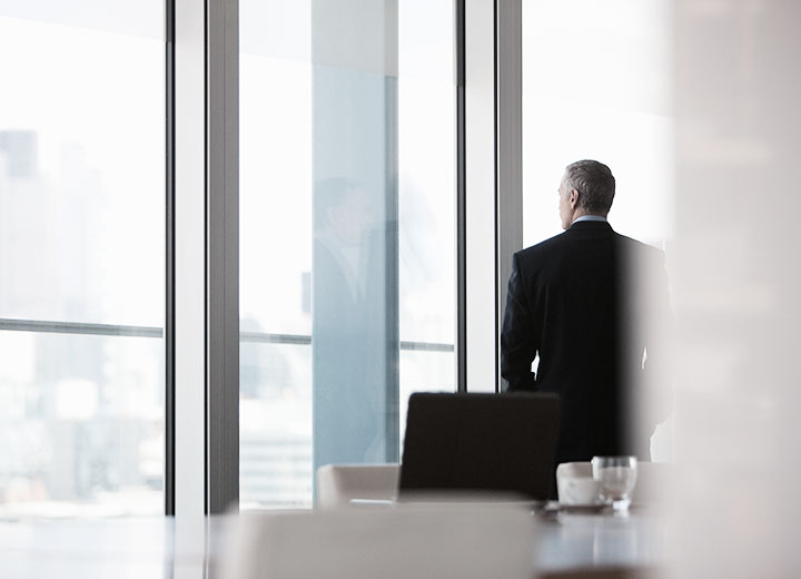 Businessman looking out of conference room window