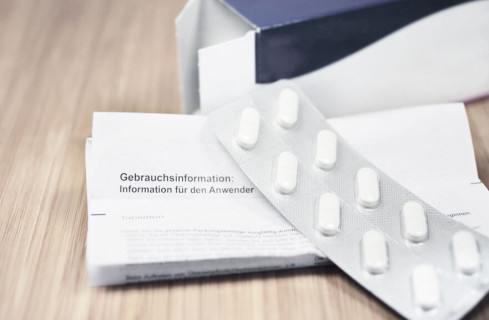 Tablet on top of a leaflet