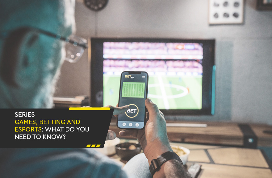 Back view of a man with a smartphone in hand using a betting app. In the bottom left corner, a black banner with the phrasse: 'Gaming, betting, and esports series: what you need to know?