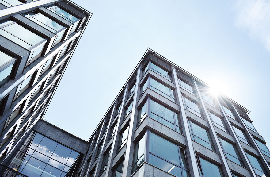 Bottom view of a mirrored building with a metal structure