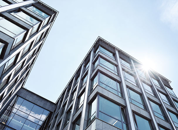 Bottom view of a mirrored building with a metal structure