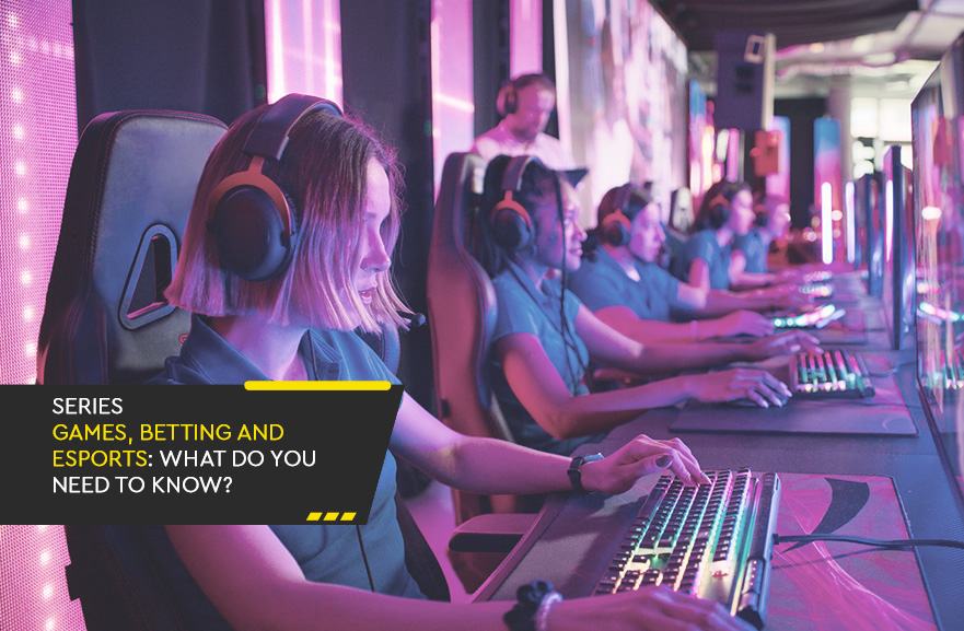 Several people sitting side by side, wearing headphones and identical computers in an online gaming competition