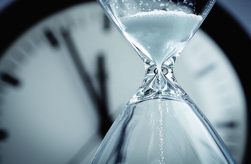 Image showing an hourglass in front of a clock