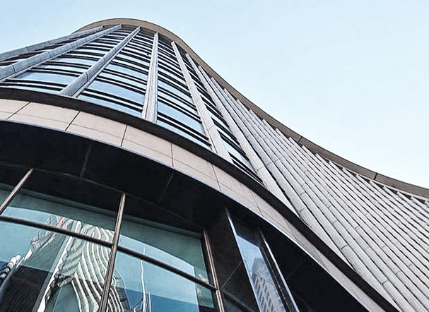Bottom view of building with mirrored glass windows