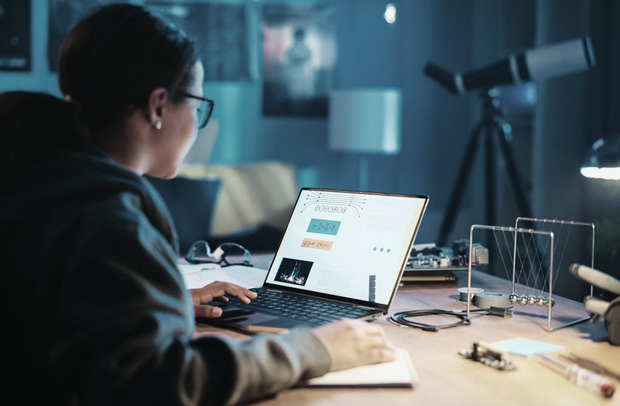 Young black teenager using a notebook to study.