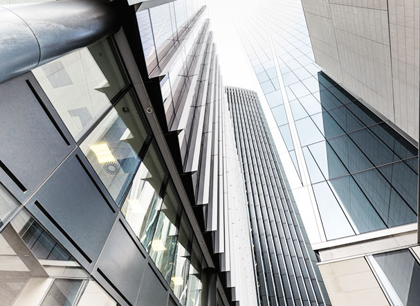 Bottom view of building with mirrored windows and metal structures
