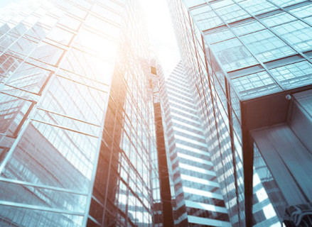 Lower view of buildings mirrored in blue