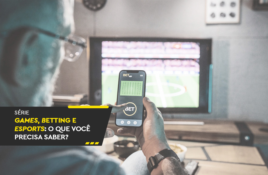 Visão traseira de homem com smartphone na mão utilizando aplicativo de apostas. No canto inferior esquerdo, faixa preta com a frase: série games, betting e esports: o que você precisa saber?
